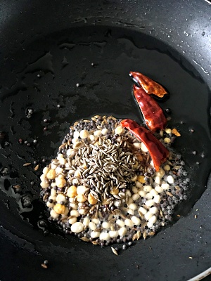 frying mustard seeds, cumin seeds, urad dal and red chilies