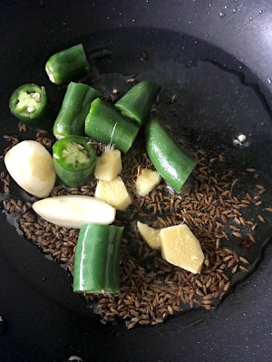 Saute chilies, cumin, garlic and ginger